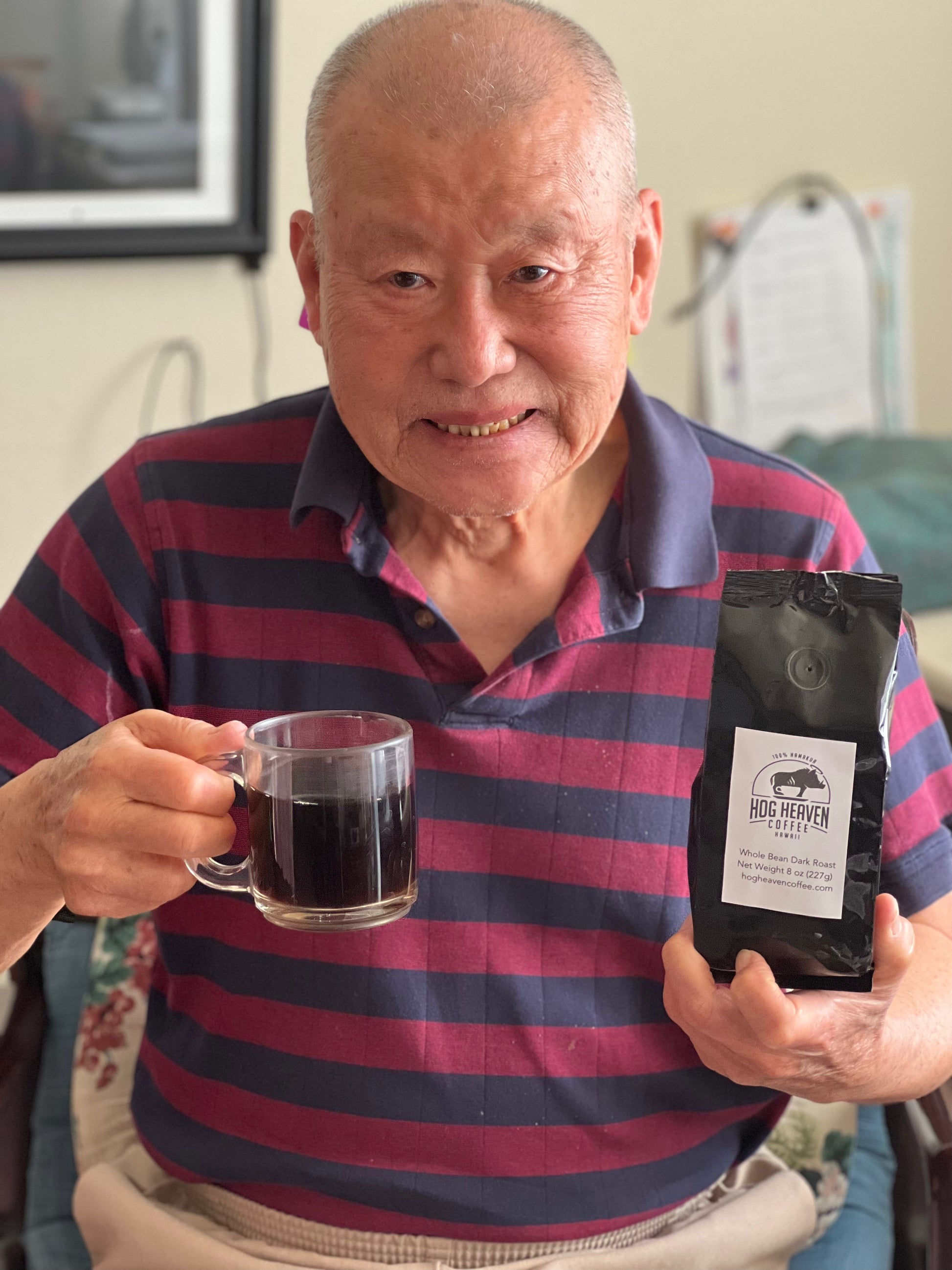 man with big smile drinking Hog Heaven Coffee