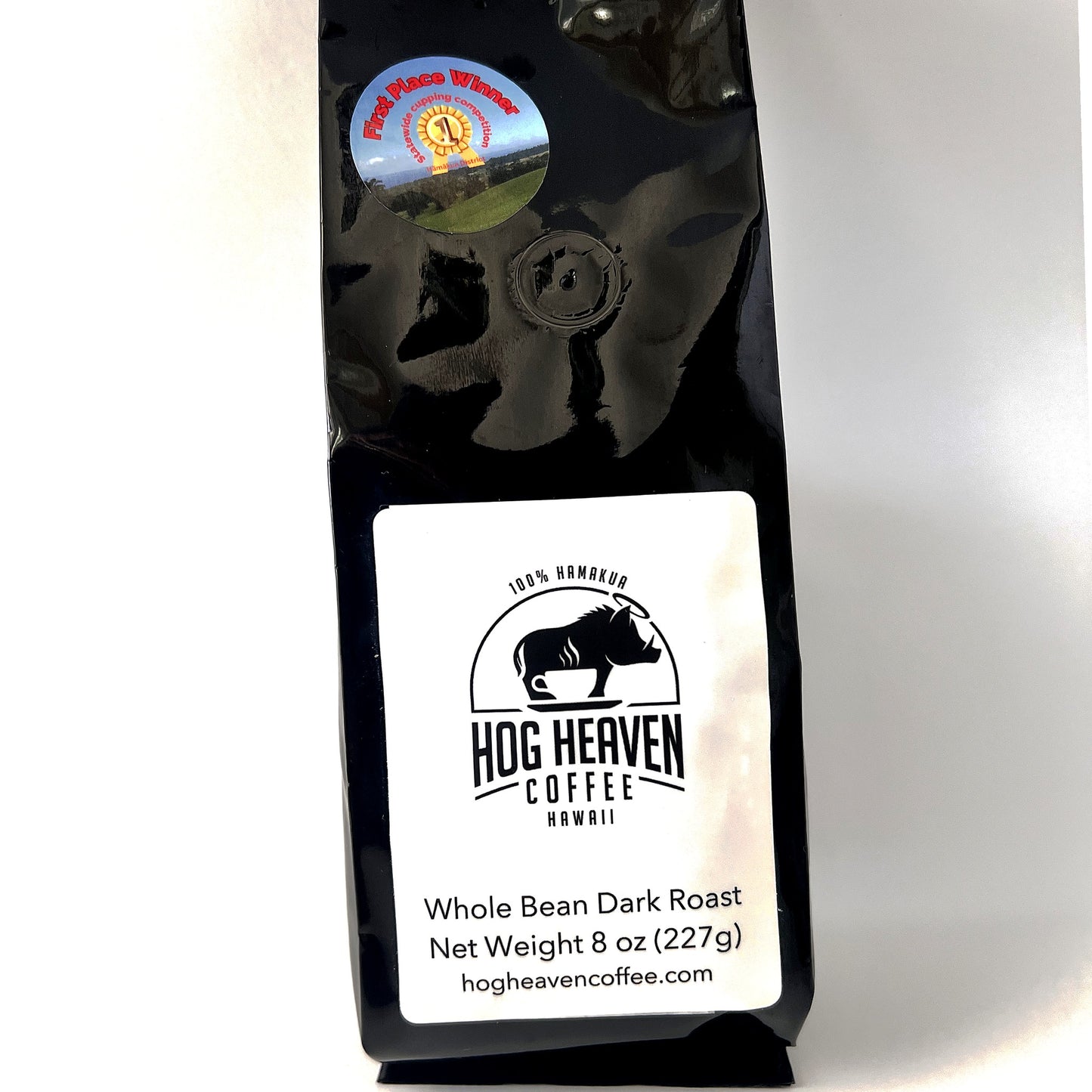 Black bag of Hog Heaven Coffee 8 oz dark roast with a white label on a white background