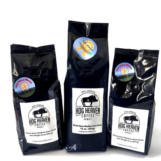 Three medium dark coffee bags with 'Hog Heaven Coffee' labels on a white background