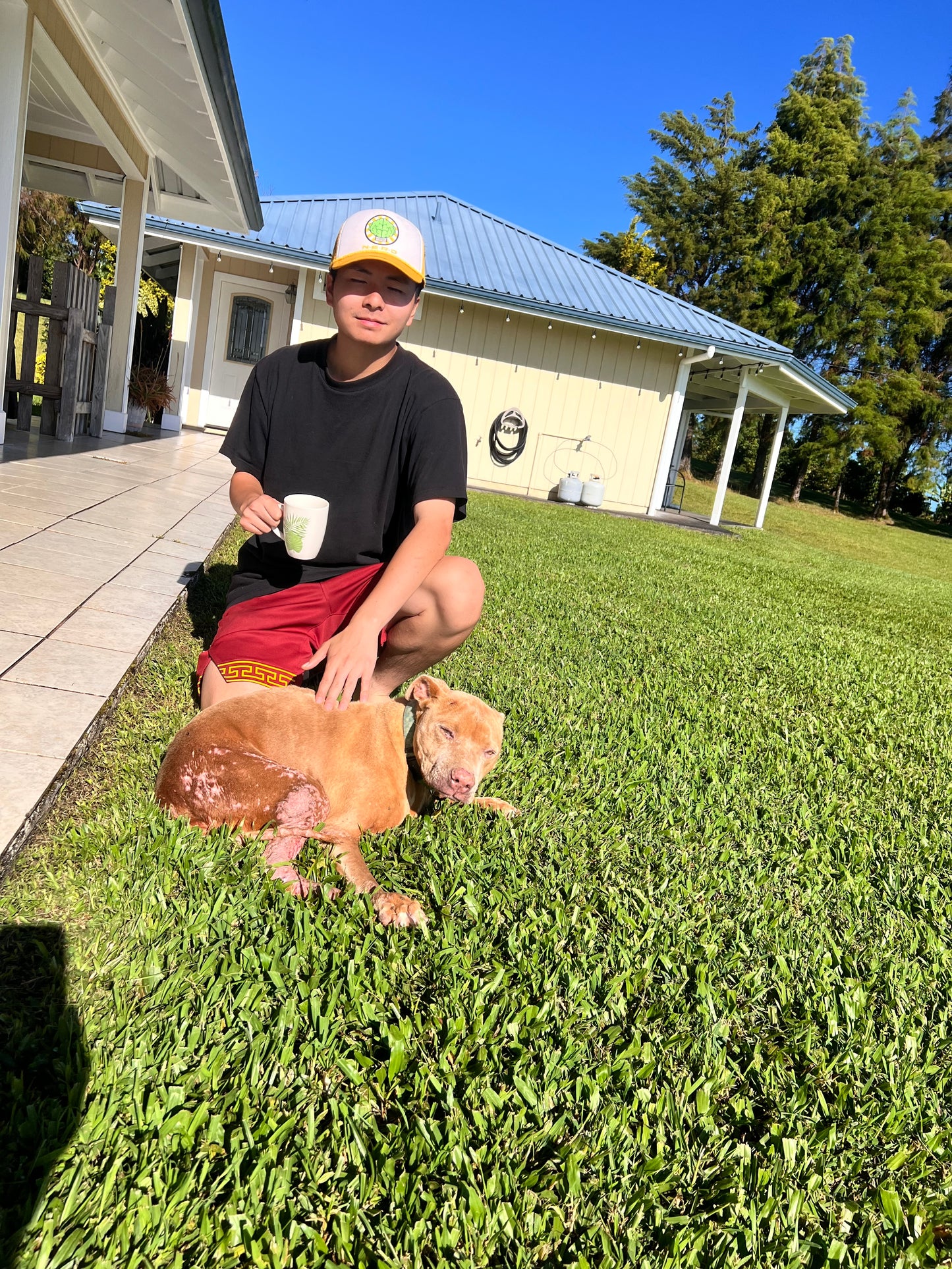 man with mug of Hog Heaven coffee with Hazel, the coffee princess dog
