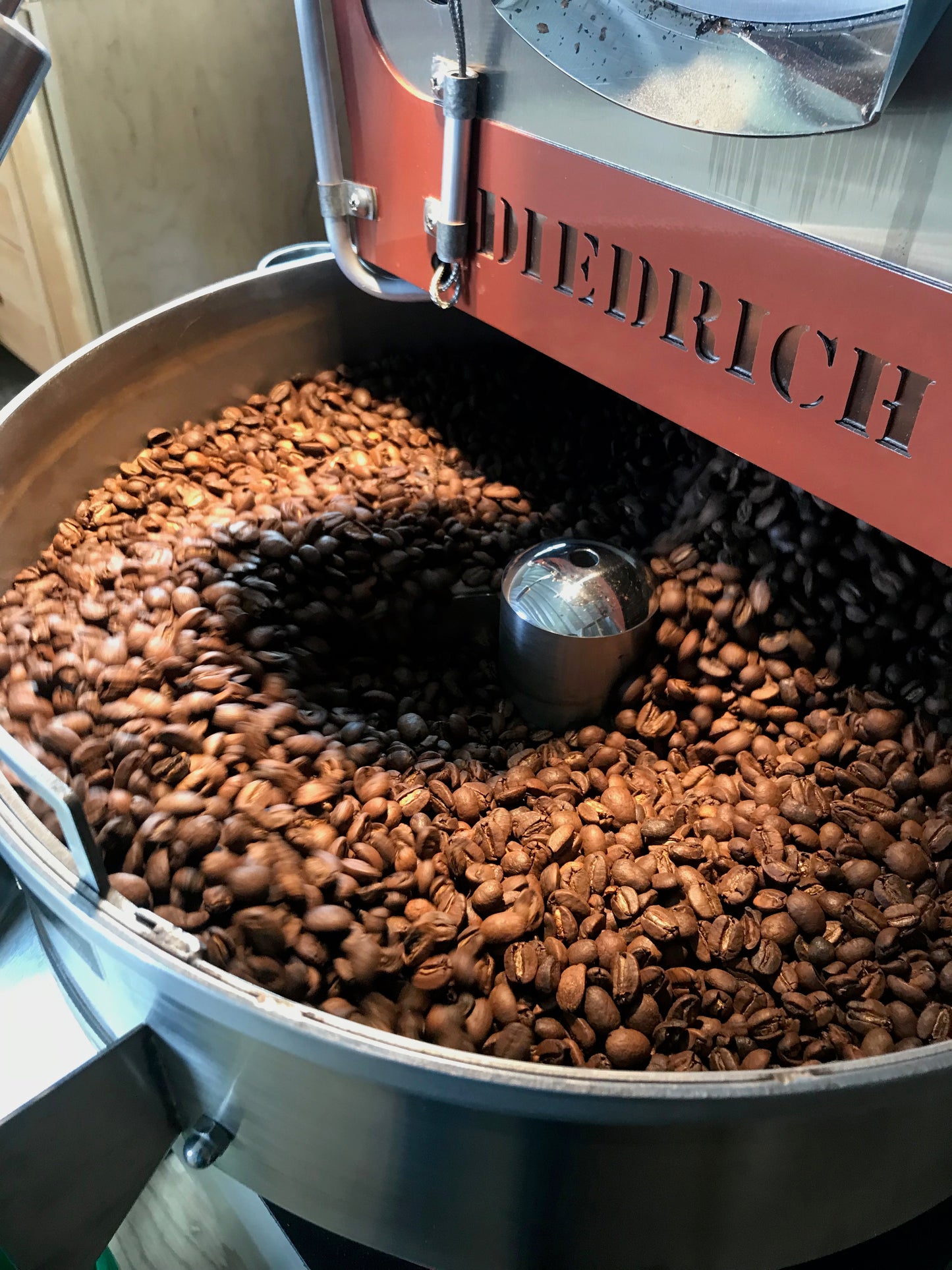 image of roasted coffee on cooling bin of small batch roaster