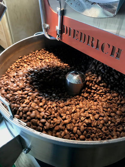 image of roasted coffee on cooling bin of small batch roaster