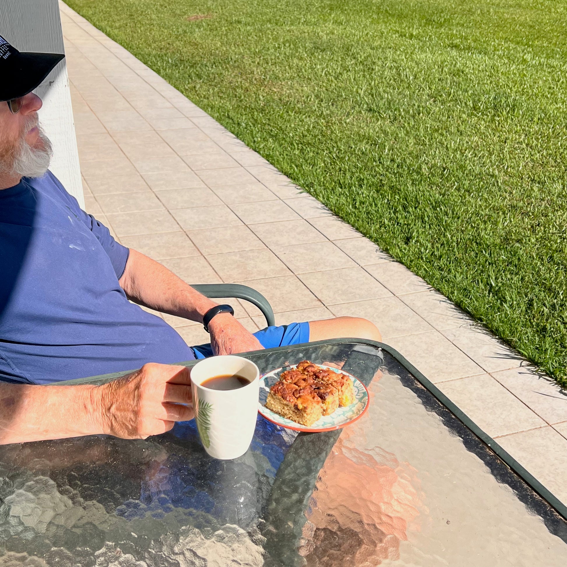 man with mug of Hog Heaven Coffee with view
